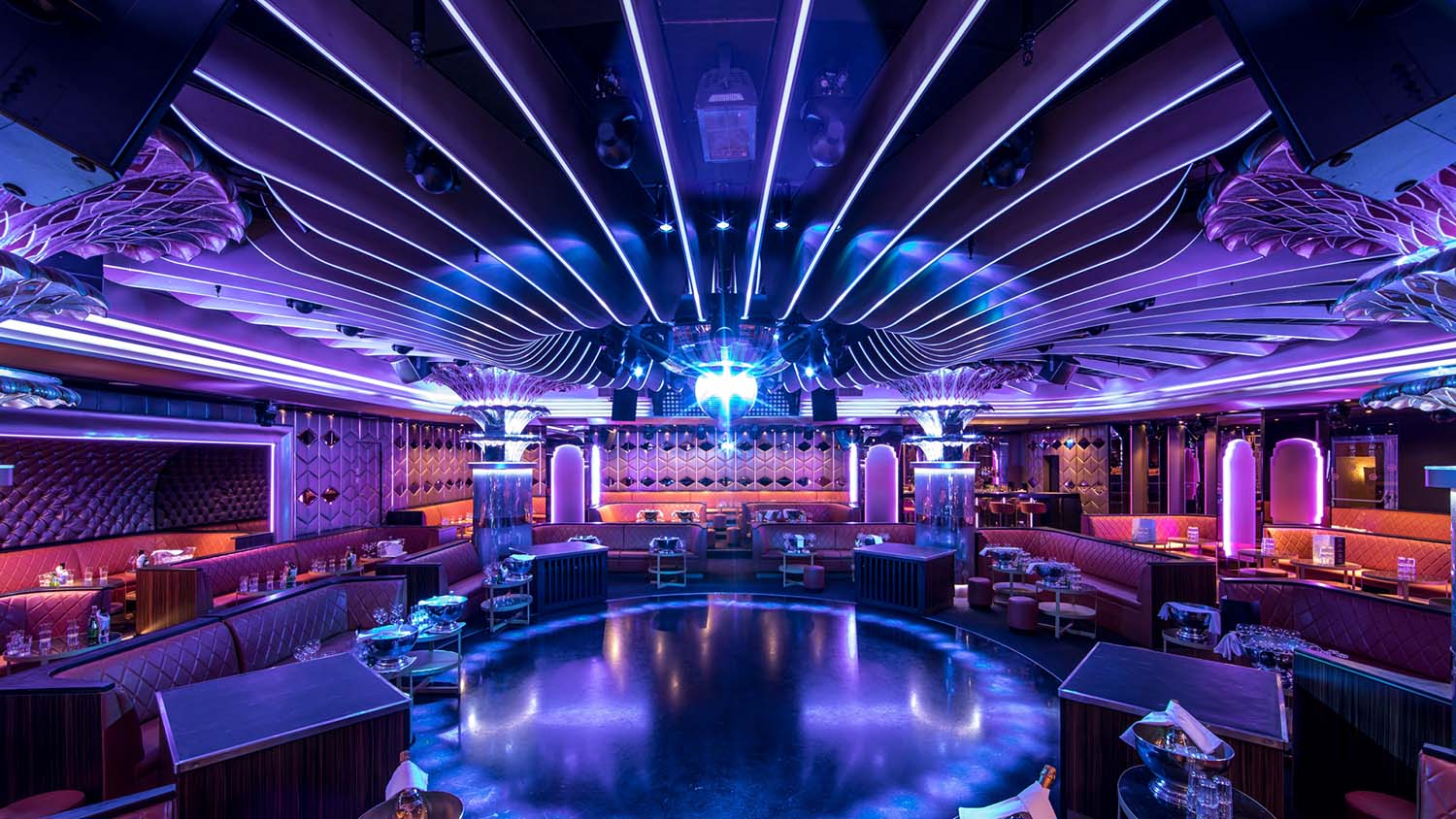 Bar and lounge interior with continuous colour light lines along the walls and back bar