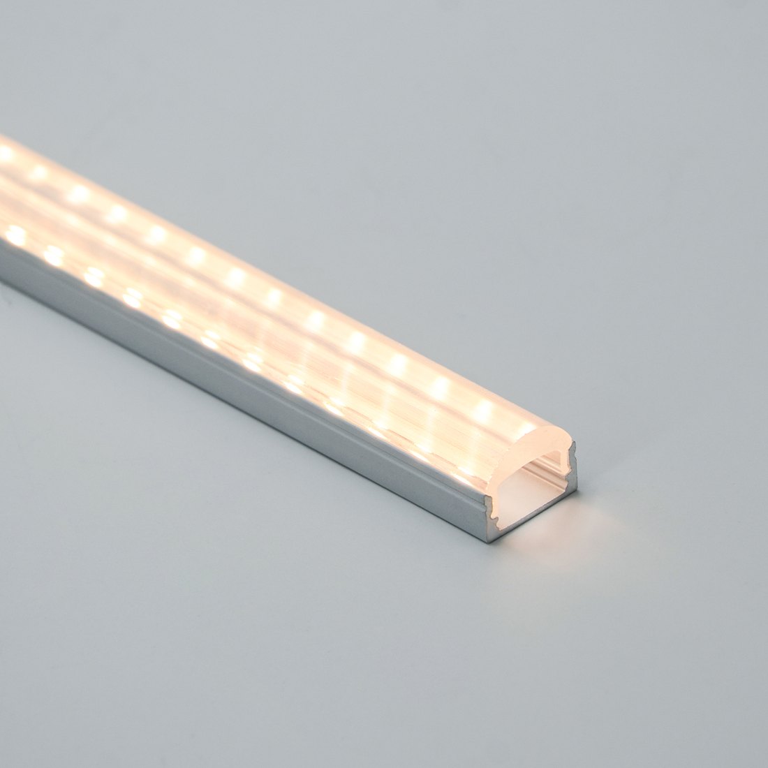 PMMA lens profile lit at an angle, showing the prism structure and concentrated beam
